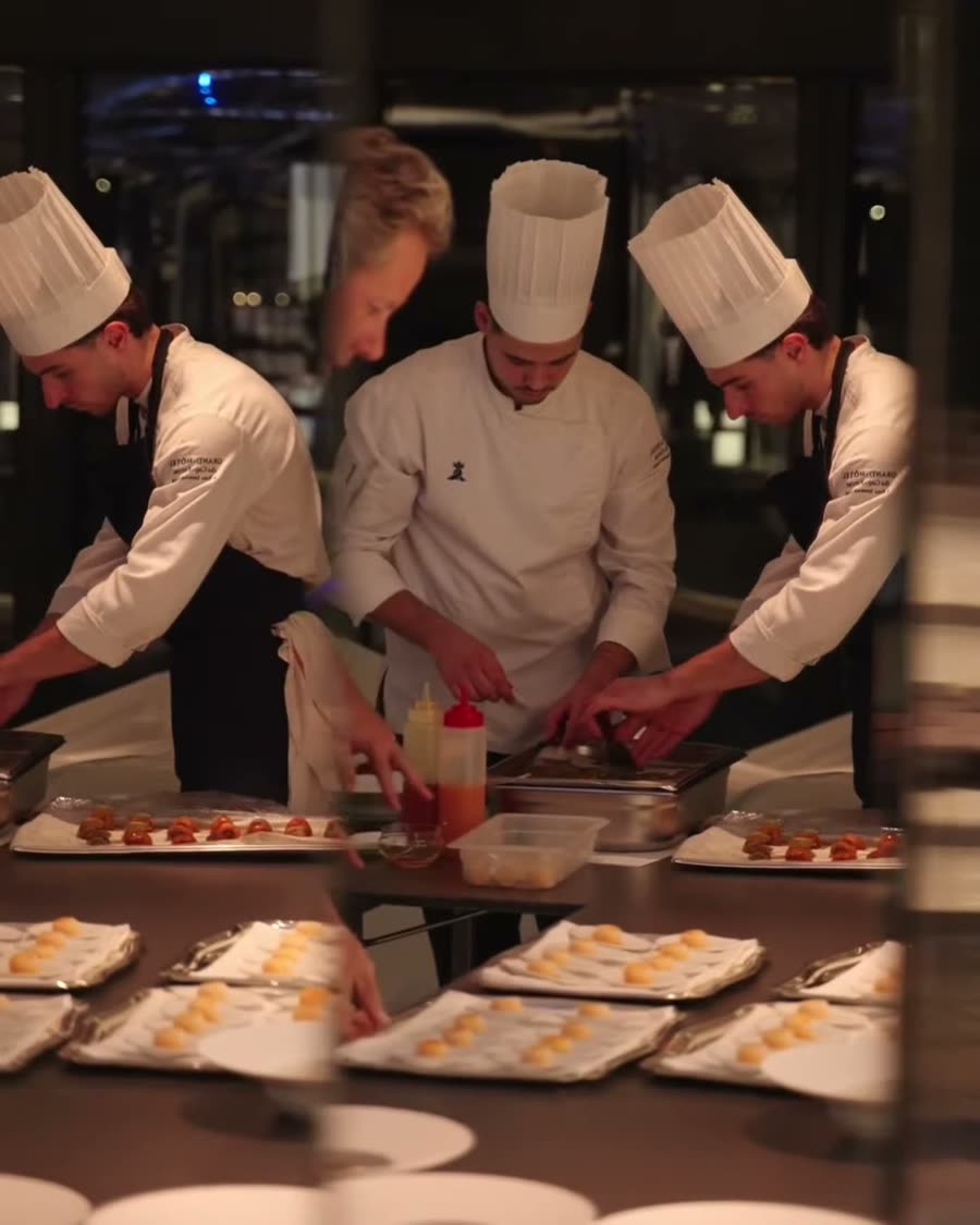 Chefs plating dinner aboard a Four Seasons yacht